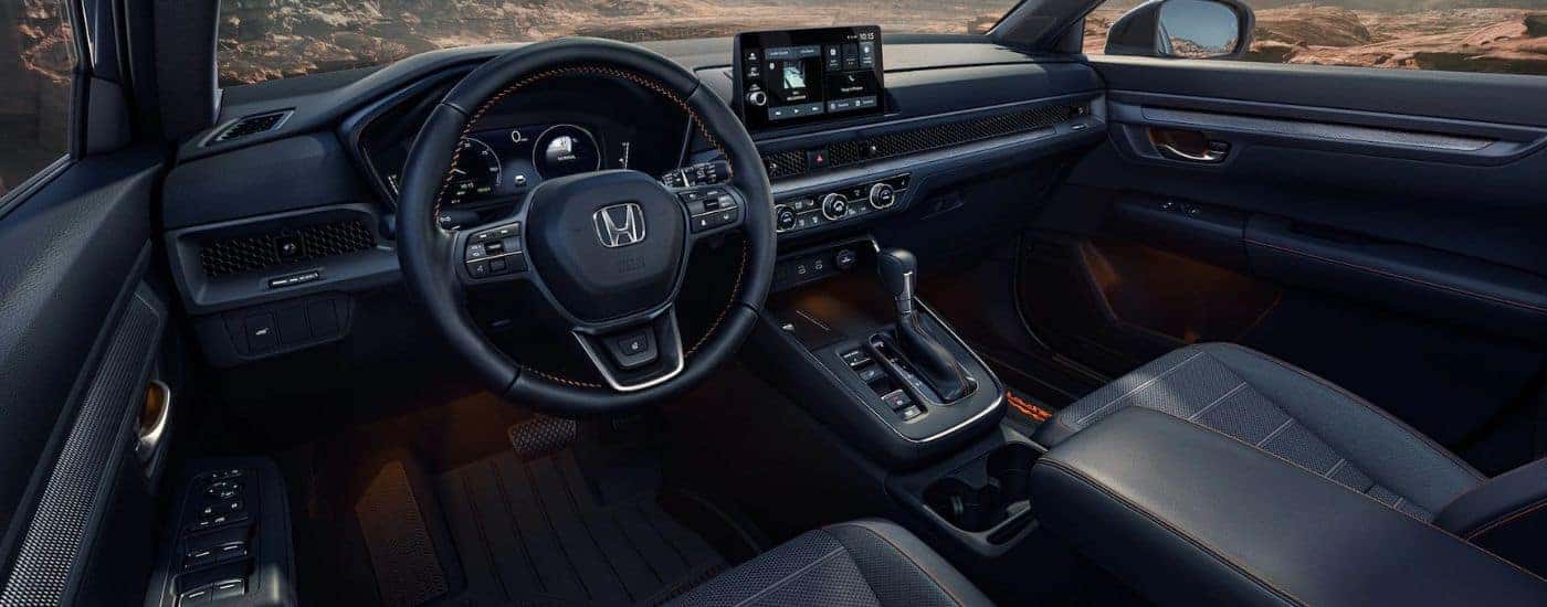 2026 Honda CR-V black front interior with steering wheel and infotainment.