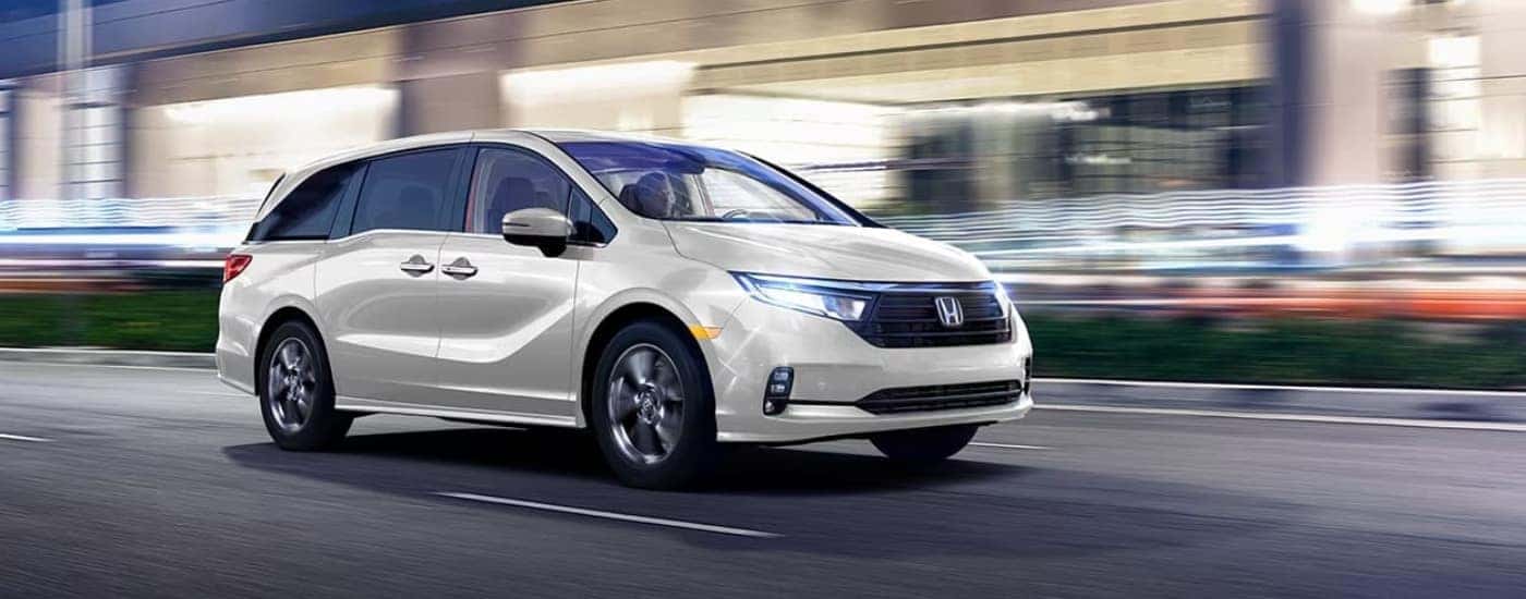 A white 2023 Honda Odyssey driving at night.