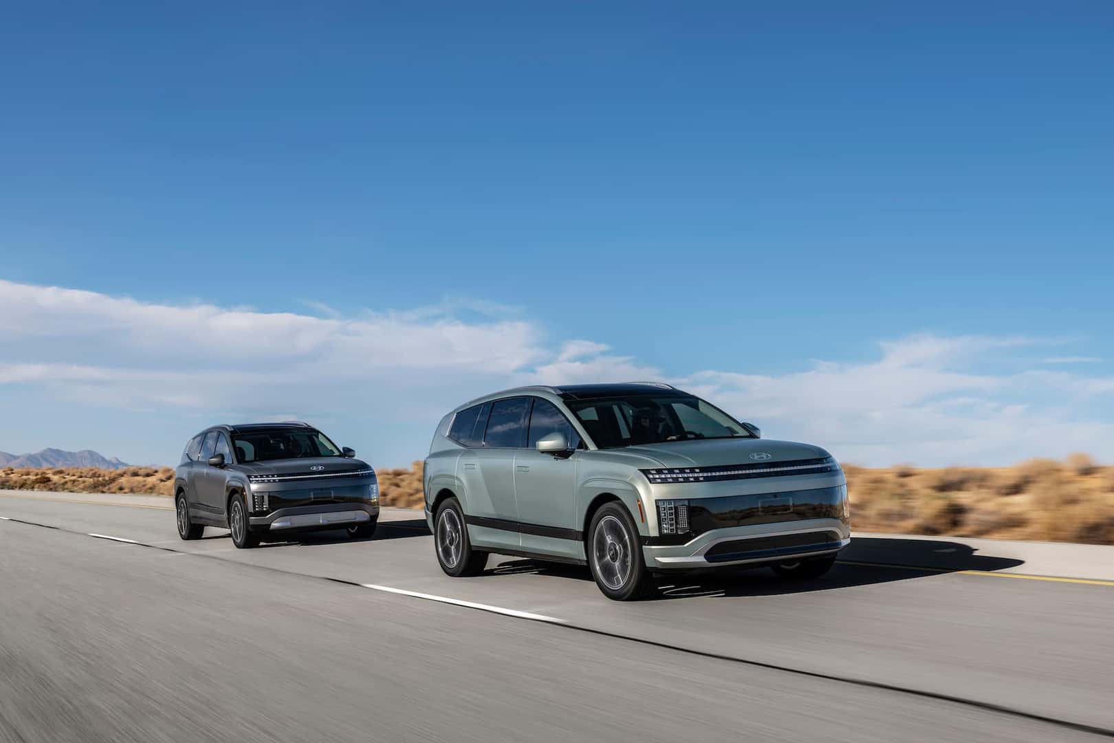 two 2026 IONIQ 9 vehicles on a highway road