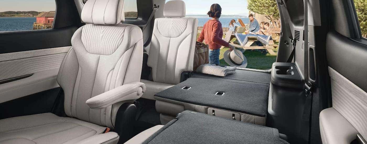 The white interior seating and storage capacity of a 2025 Hyundai Palisade for sale.