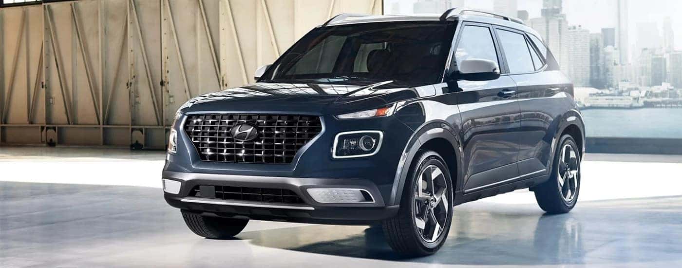 A blue 2025 Hyundai Venue is shown from the front at an angle.