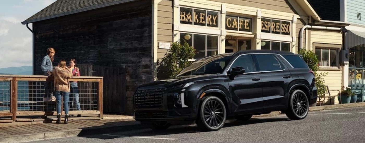 A black 2025 Hyundai Palisade is shown from the side after leaving a Hyundai dealer near Winter Garden.
