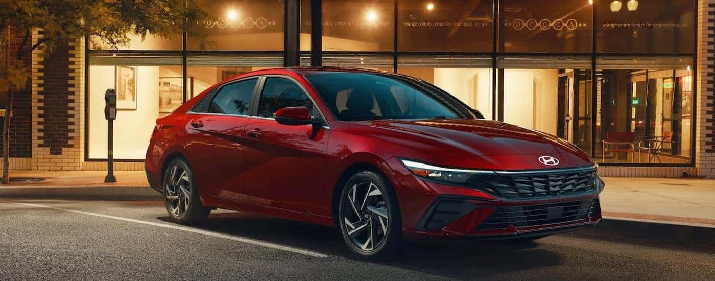A red 2025 Hyundai Elantra Limited is shown parked on a parking spot.