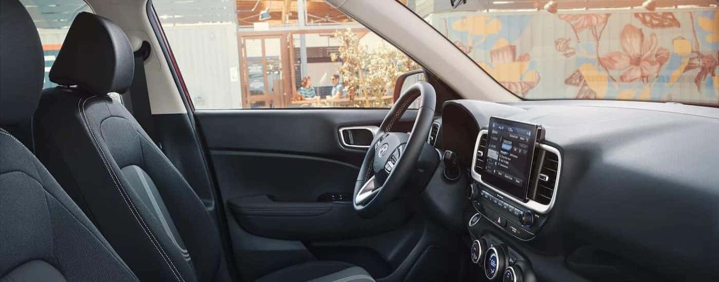 The black interior and dash are shown in a2025 Hyundai Venue.