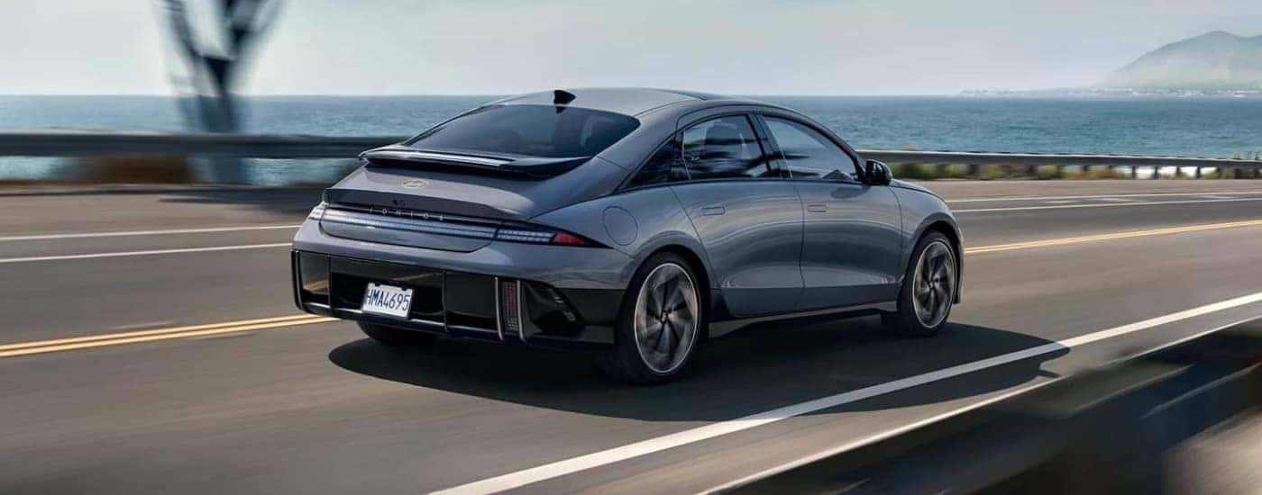 A silver 2023 Hyundai IONIQ 6 is shown driving to a Hyundai dealer near Kissimmee.