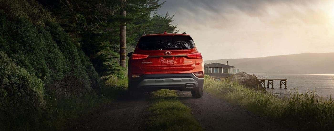 A red 2020 Hyundai Santa Fe is parked on a coastal trail.