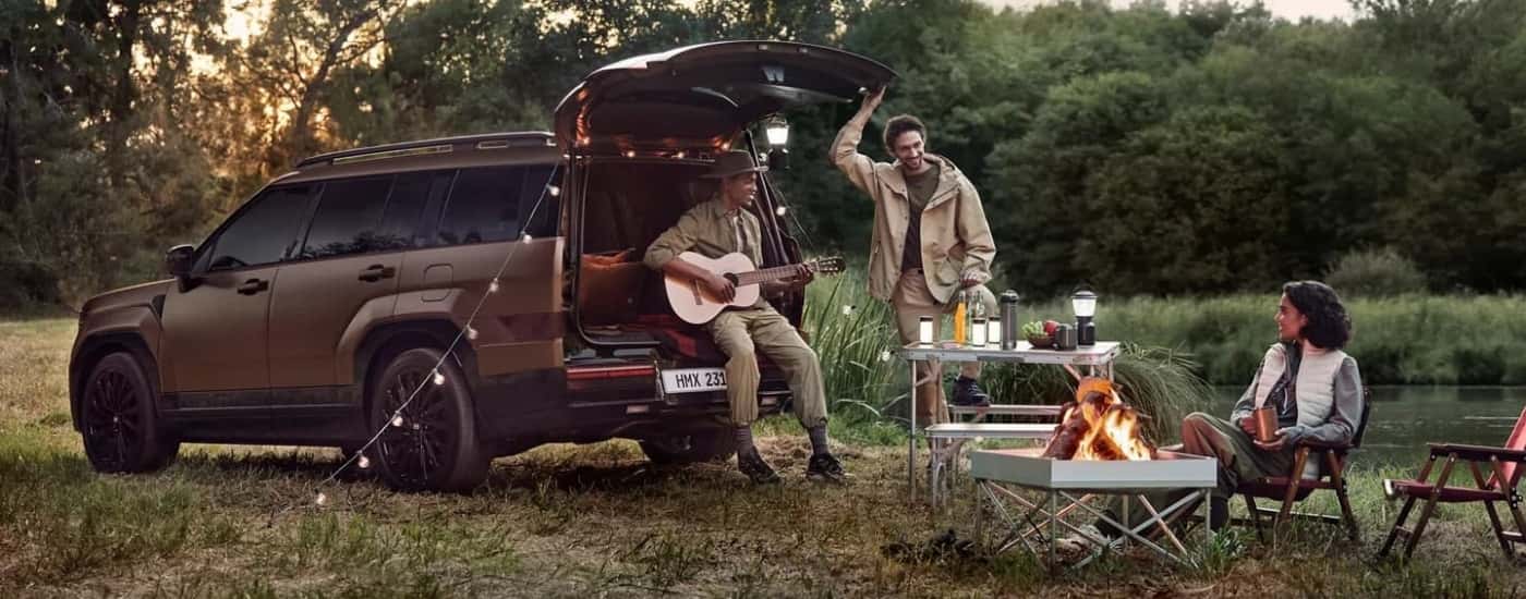 A brown 2025 Hyundai Santa Fe for sale is parked at a campsite.