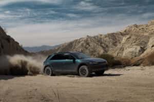 A green Hyundai IONIQ 5 off-roading