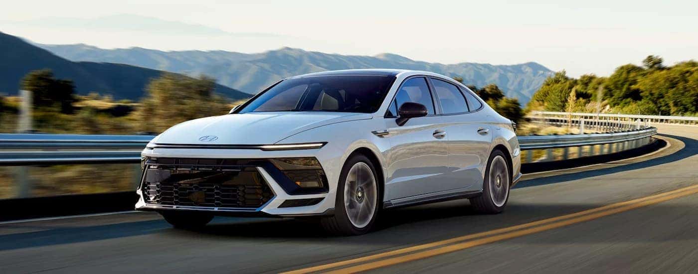 A white 2025 Hyundai Sonata driving down a highway