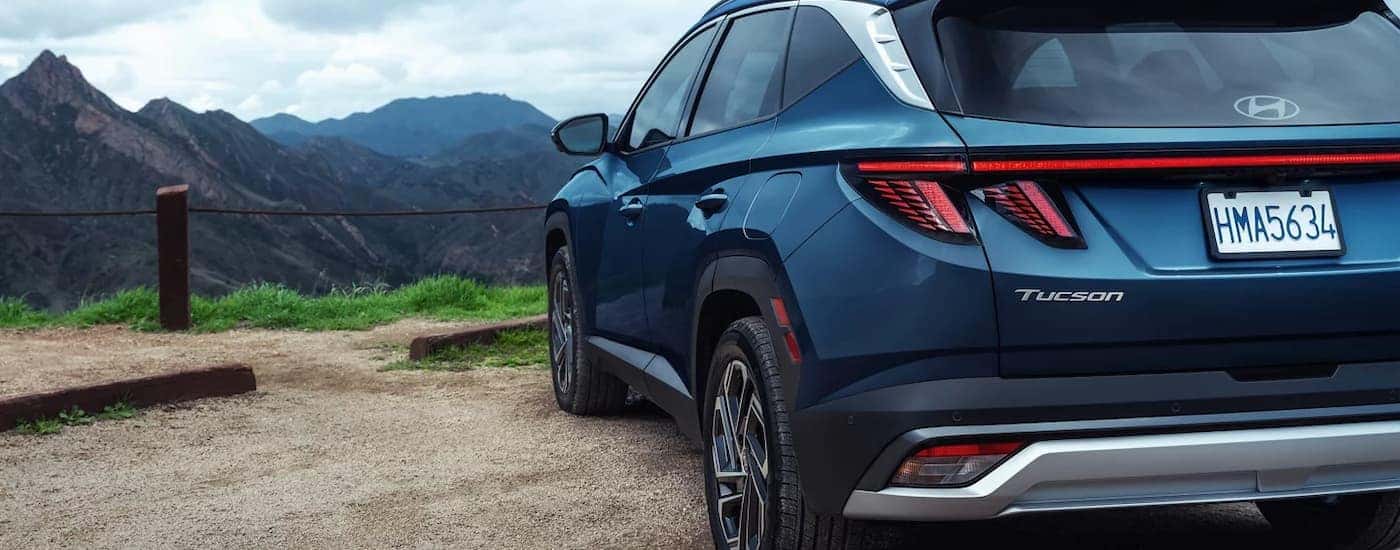 A blue 2025 Hyundai Tucson for sale parked off-road