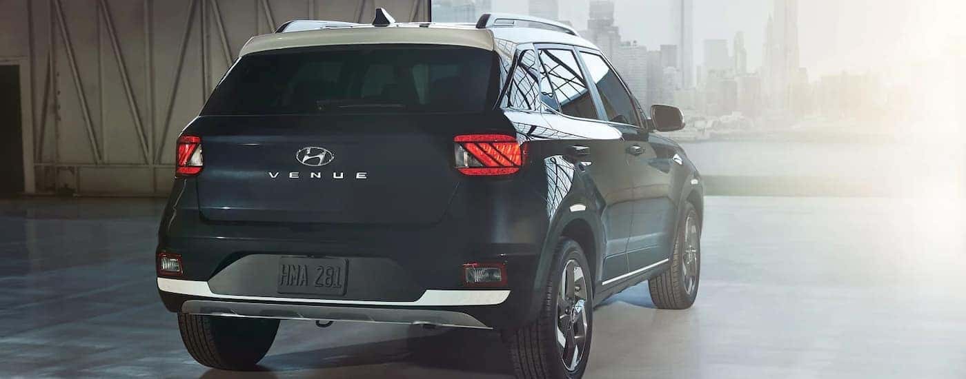 A black 2025 Hyundai Venue parked near a city