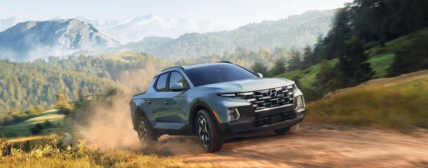 A blue 2023 Hyundai Santa Cruz off-roading after visiting a Hyundai dealer near Orlando.