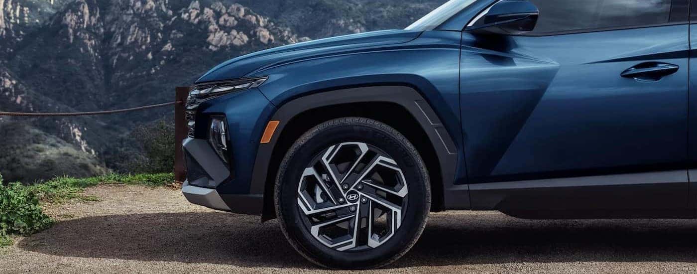 The front-end of a blue 2025 Hyundai Tucson.