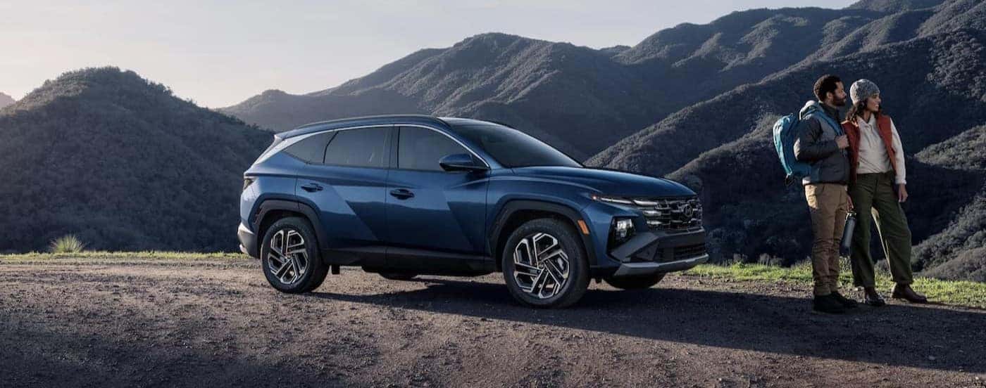 A blue 2025 Hyundai Tucson parked on a mountain.
