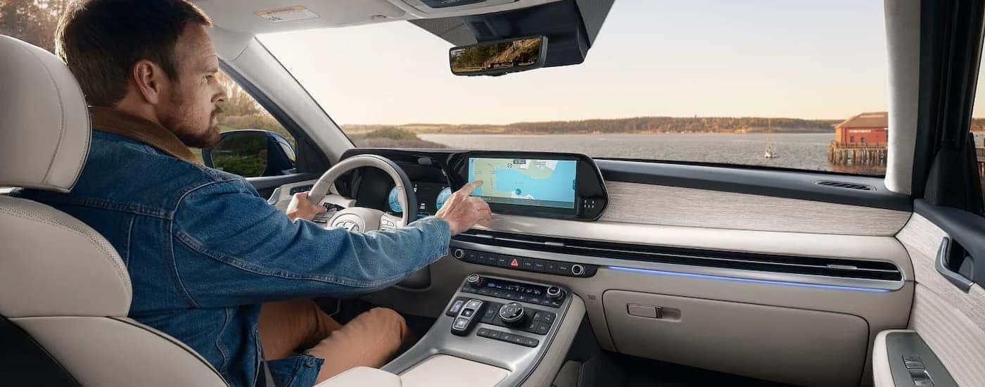 Man test driving in a 2025 Hyundai Palisade for sale in Clermont