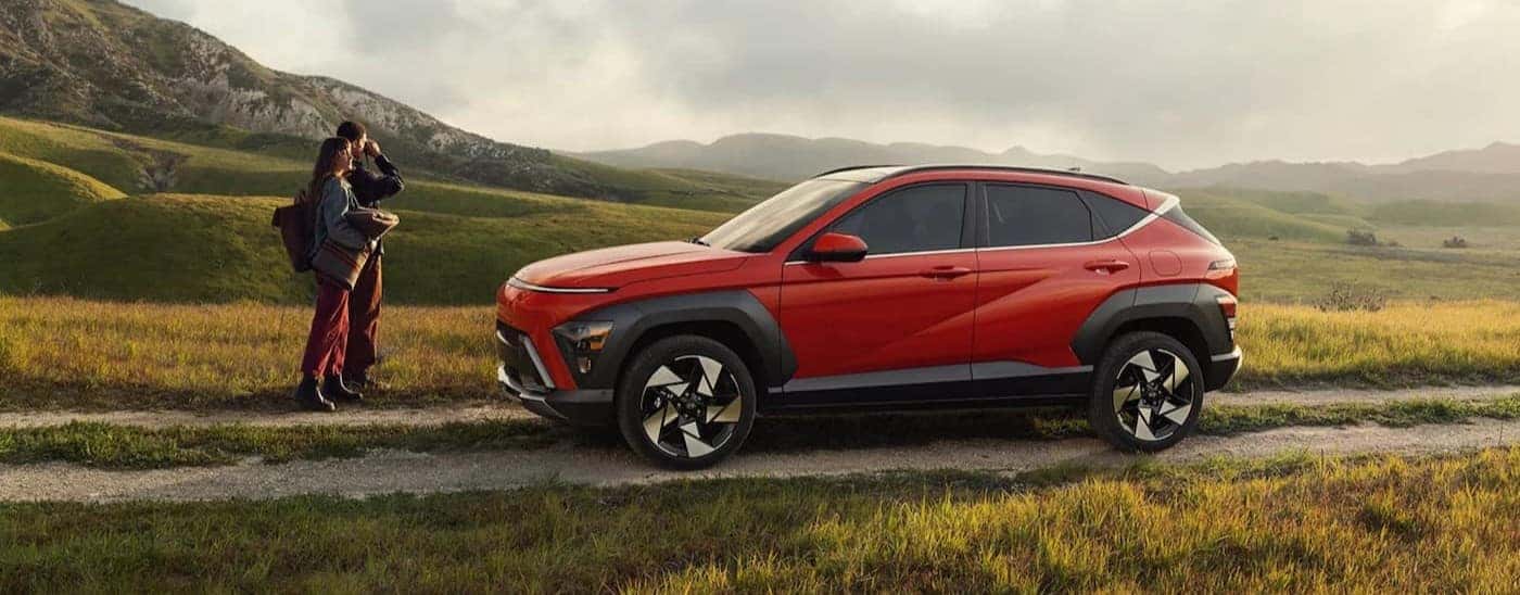 A red 2026 Hyundai Kona parked on a dirt path.