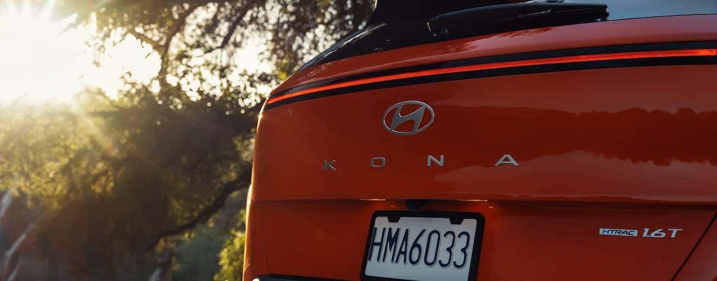 Rear badge and taillights of a red 2026 Hyundai Kona