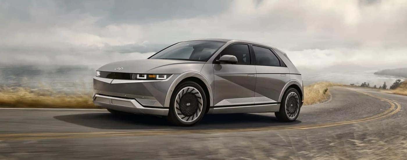 Grey 2023 Hyundai IONIQ 5 driving on a winding road