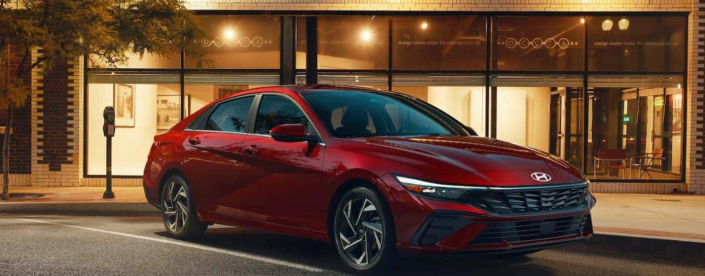 A red 2025 Hyundai Elantra parked outside a building