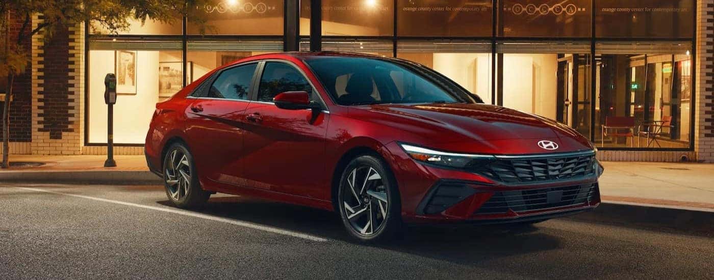 A red 2026 Hyundai Elantra parked in a city.