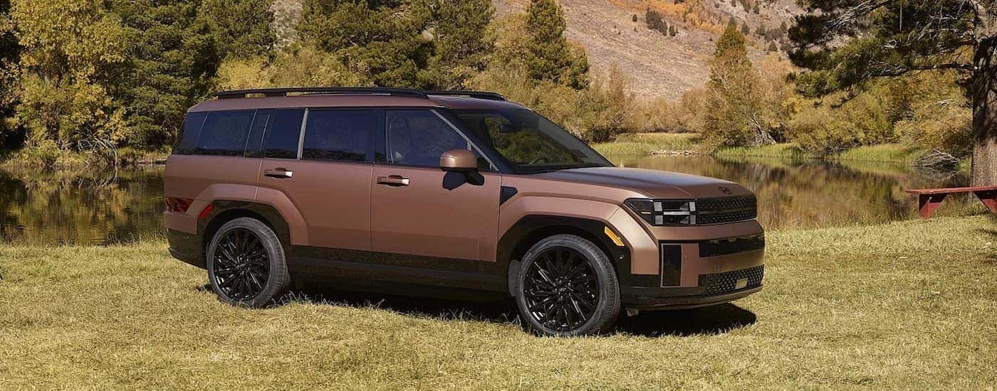A bronze 2025 Hyundai Santa Fe for sale near Orlando from the side.