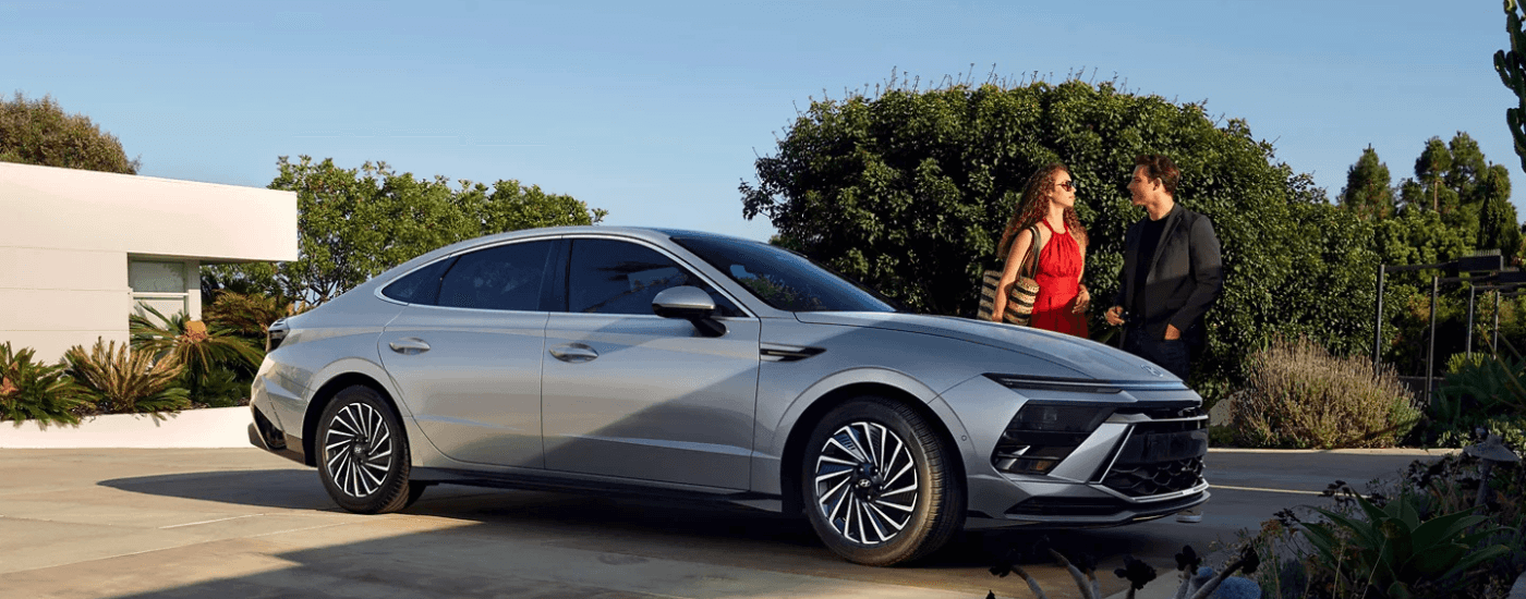 Silver 2026 Hyundai Sonata with a couple getting out of it