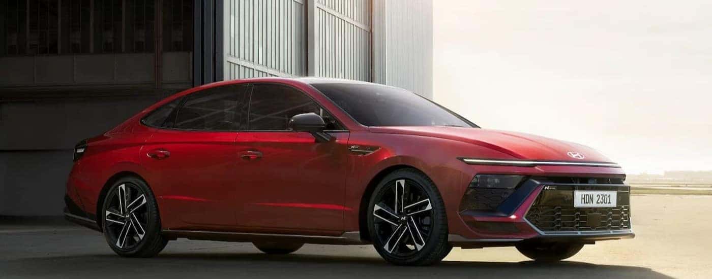A red 2024 Hyundai Sonata parked off-road