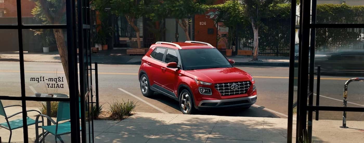 A red 2026 Hyundai Venue for sale near The Villages from the front.