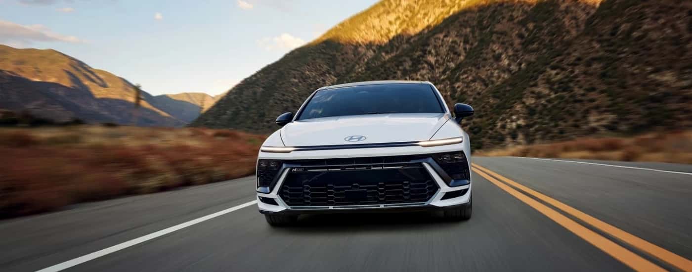 A white 2025 Hyundai Sonata N Line driving down a highway