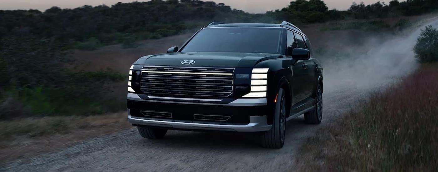 A black 2026 Hyundai Palisade off-roading on a trail
