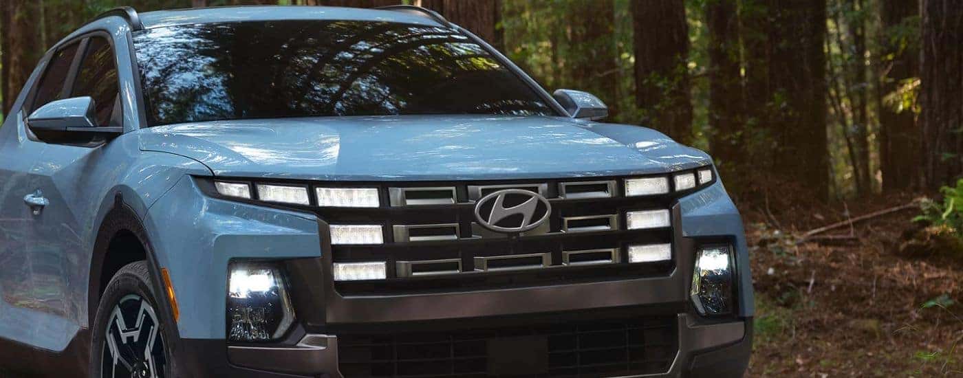 A blue 2026 Hyundai Santa Cruz Limited shown parked in the woods.