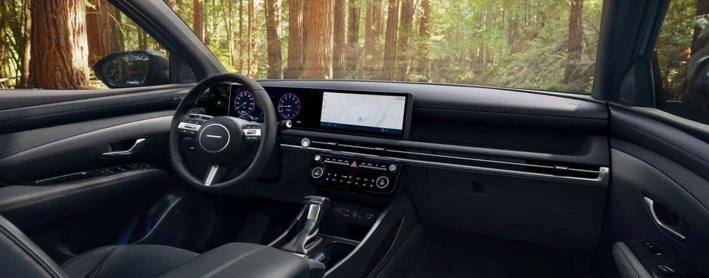 Interior view of a 2026 Hyundai Santa Cruz infotainment, steering wheel and digital gauge cluster.