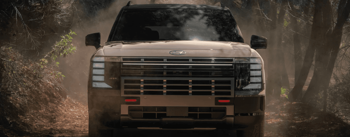 Brown 2026 Hyundai Palisade XRT Pro driving down a trail