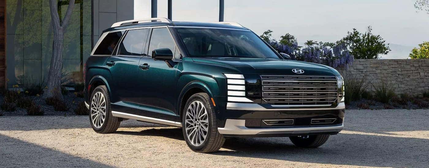A blue 2026 Hyundai Palisade parked in a driveway