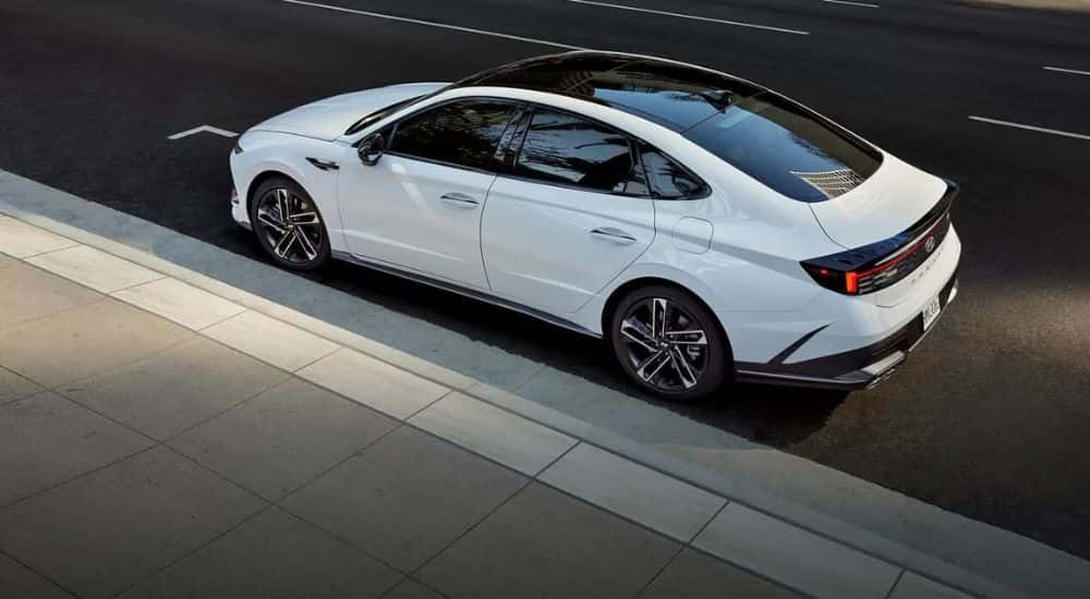Aerial view of a white 2024 Hyundai Sonata N-Line parked in a city.