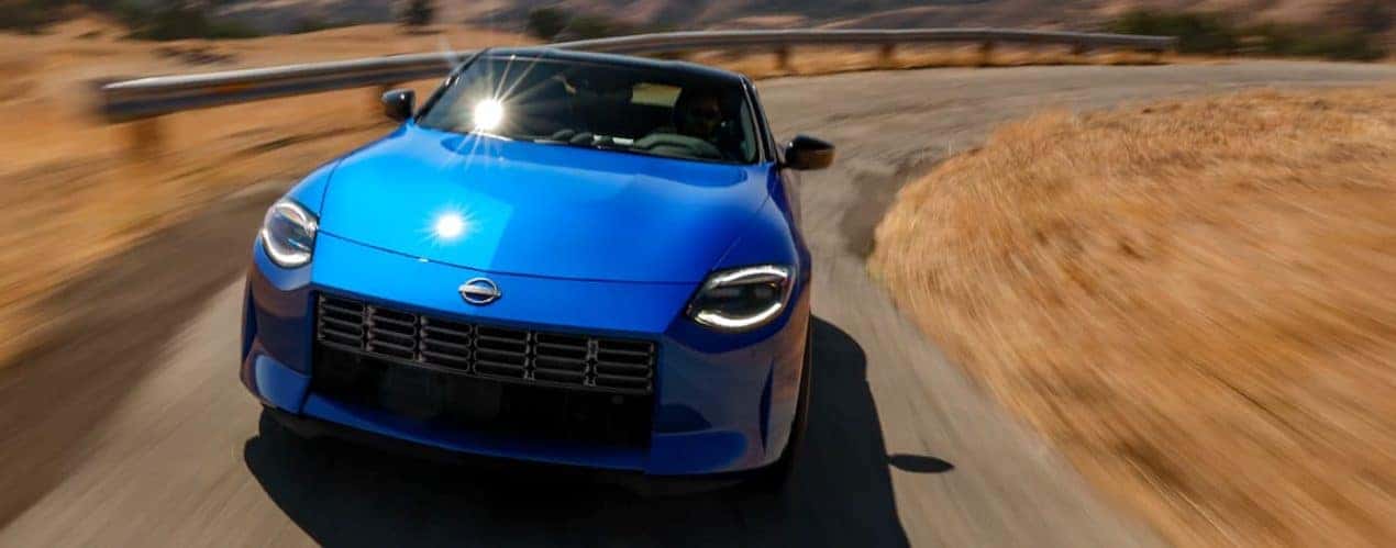 A blue 2021 Nissan Z is shown from the front against a burred background.