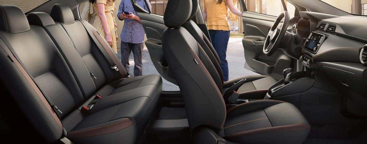 The grey interior of a 2022 Nissan Versa shows two rows of seating.