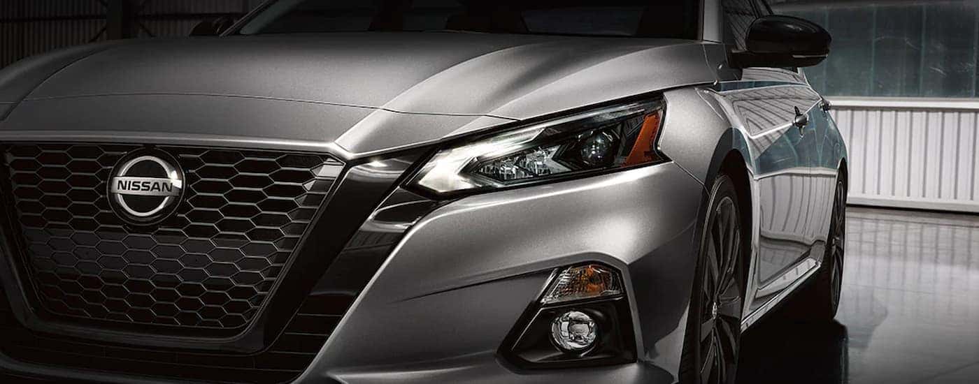 A close up of the grille of a silver 2022 Nissan Altima Midnight is shown during a 2022 Nissan Altima vs 2022 Toyota Camry comparison.
