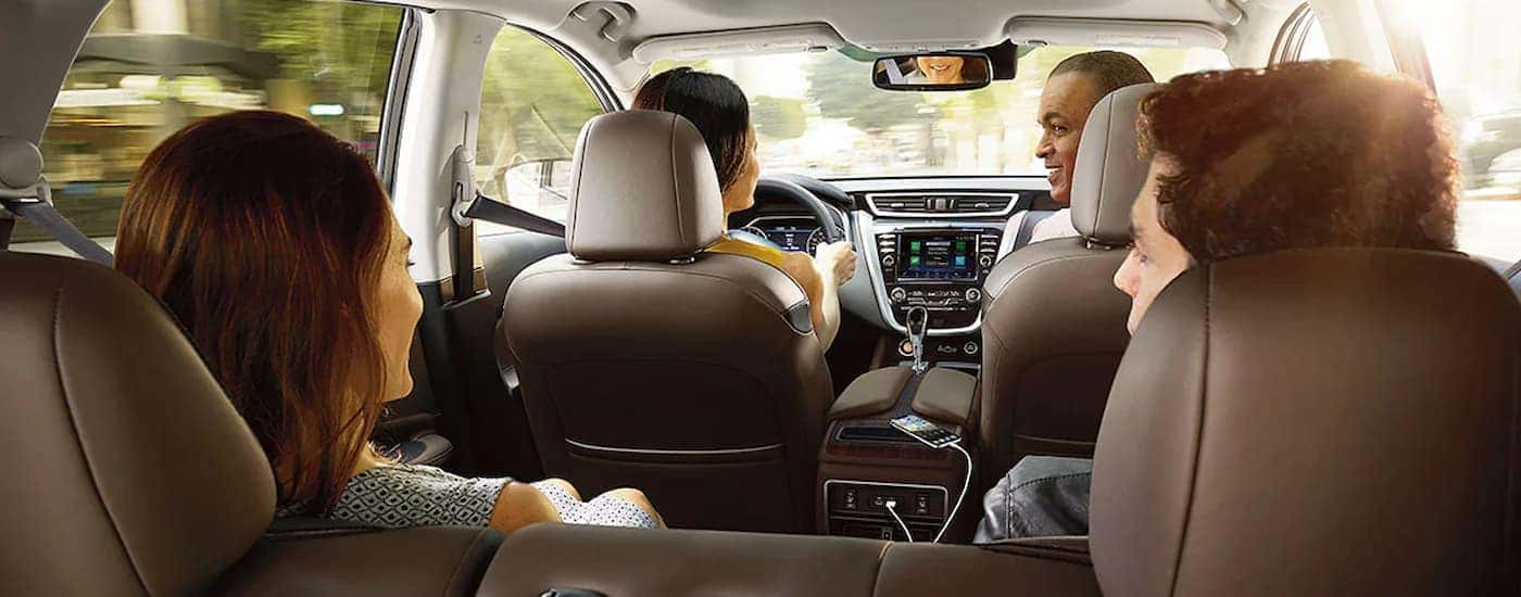 A group a friends is shown driving in a 2022 Nissan Murano.
