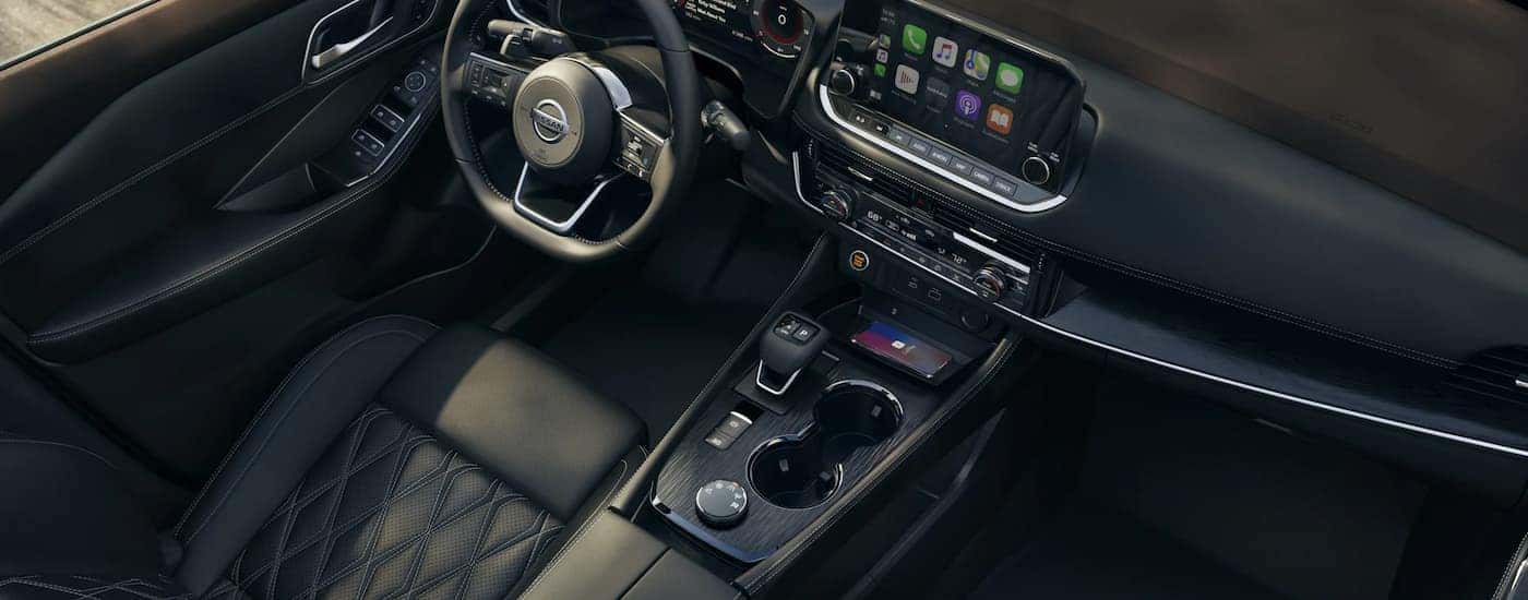 The black interior of a 2022 Nissan Rogue is shown during a 2022 Nissan Rogue vs 2022 Toyota RAV4 comparison.