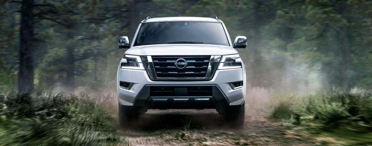 A white 2023 Nissan Armada driving off-road