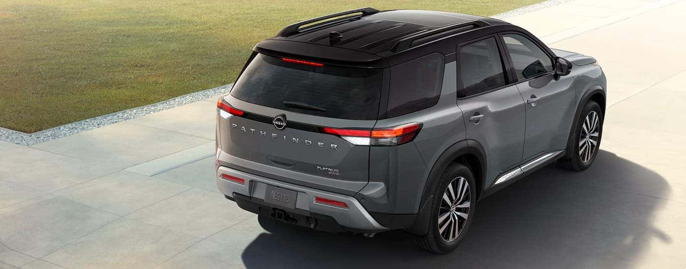 A grey 2021 Nissan Pathfinder Platinum is shown reversing on a driveway.