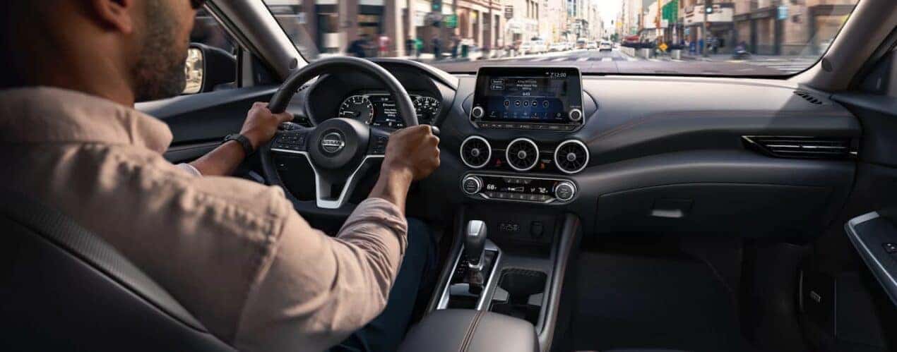 A person driving in a 2023 Nissan Sentra