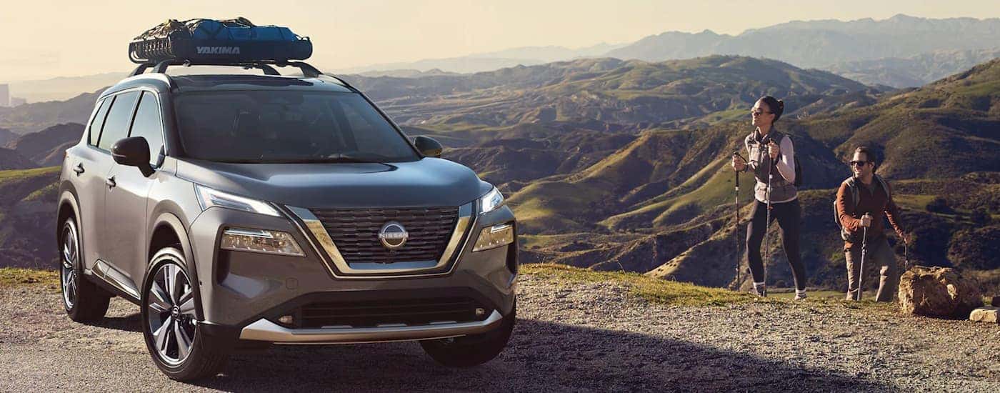 A grey 2022 Nissan Rogue is shown parked in the mountains after leaving a Nissan Rogue dealer near Le Roy, IL.