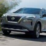 A grey 2023 Nissan Rogue is shown from the front at an angle.