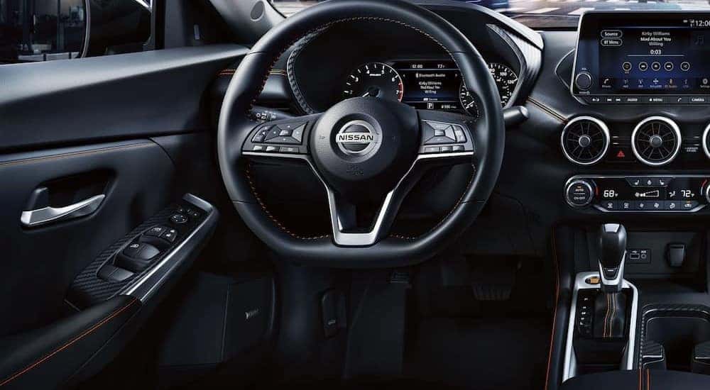 The black interior and dash of a 2023 Nissan Sentra for sale is shown.