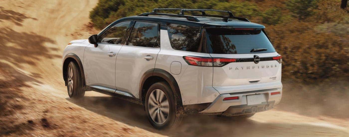 A white 2023 Nissan Pathfinder is shown from the rear at an angle.