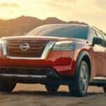 A red 2022 Nissan Pathfinder is shown from the front at an angle.
