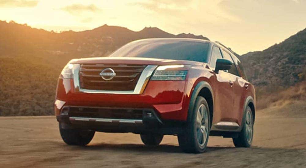 A red 2022 Nissan Pathfinder is shown from the front at an angle.
