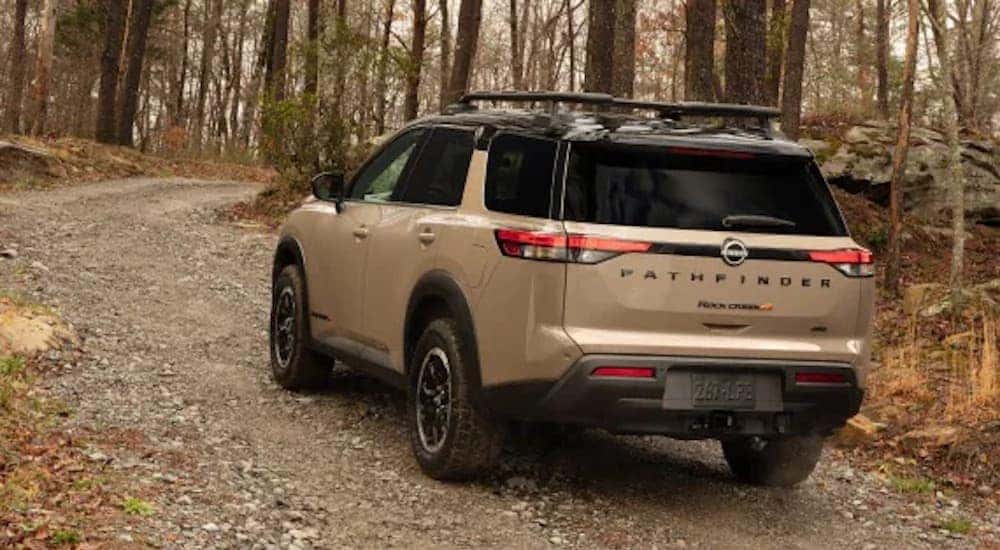A brown 2023 Nissan Pathfinder Rock Creek is shown from the rear at an angle.